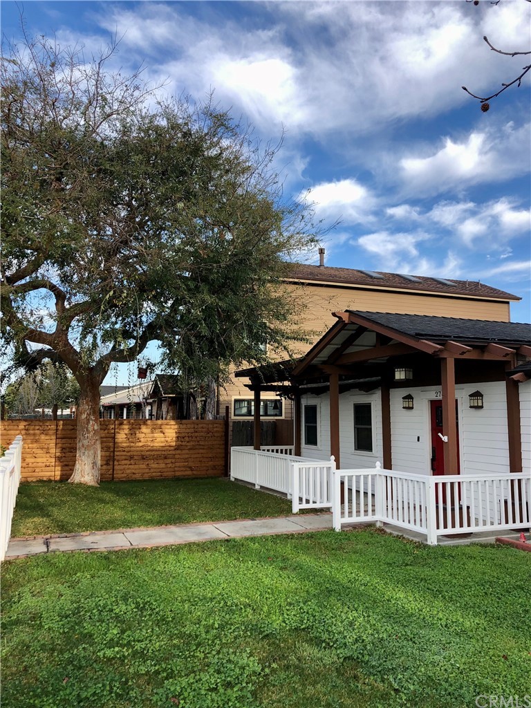 276 Esther Street Costa Mesa, CA 92627 - Photo 8 of 10 a view of a white house with a big yard and large trees