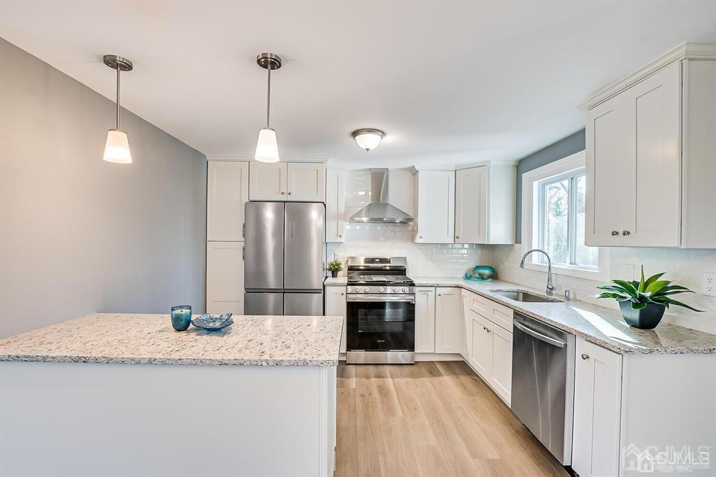 42 Norris Avenue Metuchen, NJ 08840 - Photo 12 of 39 a kitchen with granite countertop stainless steel appliances a sink a counter top space cabinets and a potted plant