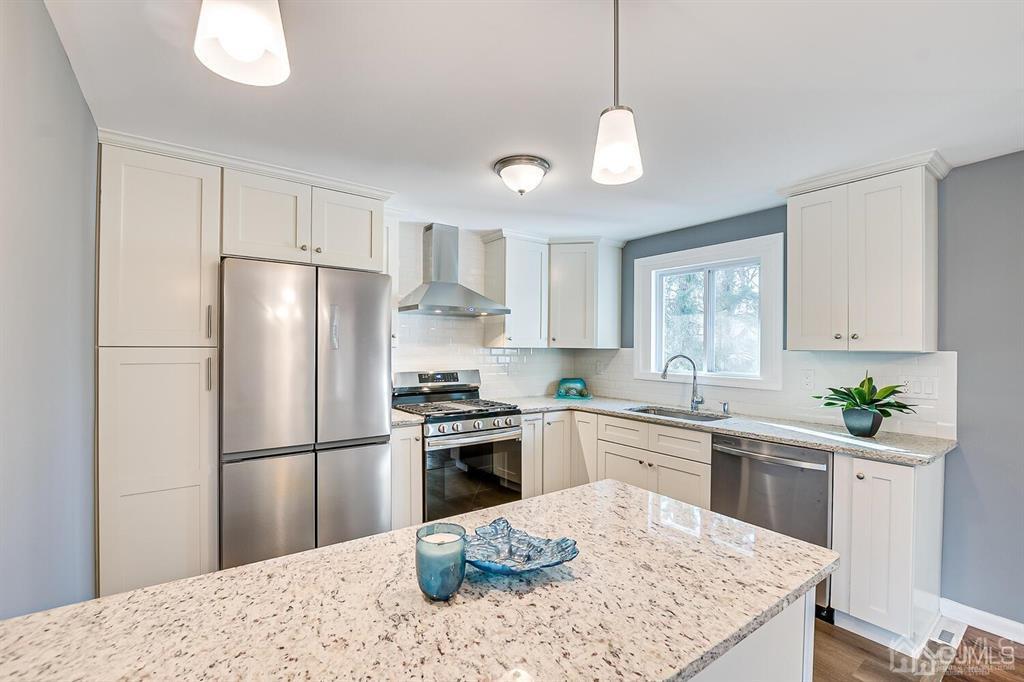 42 Norris Avenue Metuchen, NJ 08840 - Photo 13 of 39 a kitchen with stainless steel appliances kitchen island granite countertop a sink a stove a refrigerator and white cabinets
