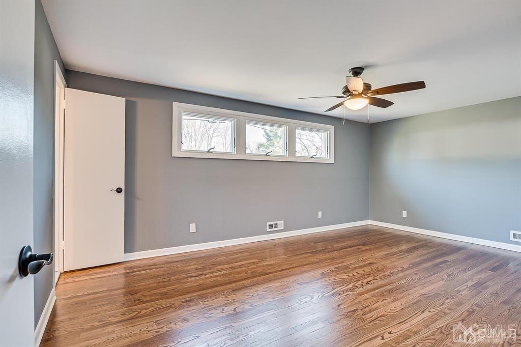 42 Norris Avenue Metuchen, NJ 08840 - Photo 19 of 39 wooden floor in an empty room with a window