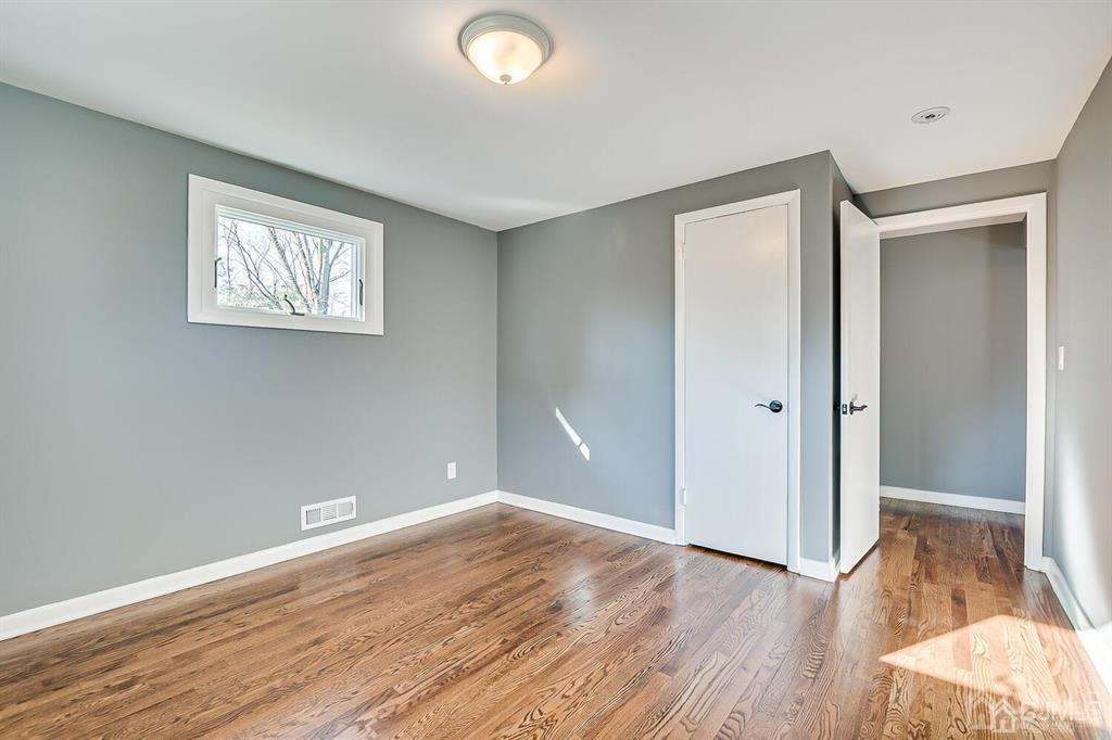 42 Norris Avenue Metuchen, NJ 08840 - Photo 24 of 39 an empty room with wooden floor and windows