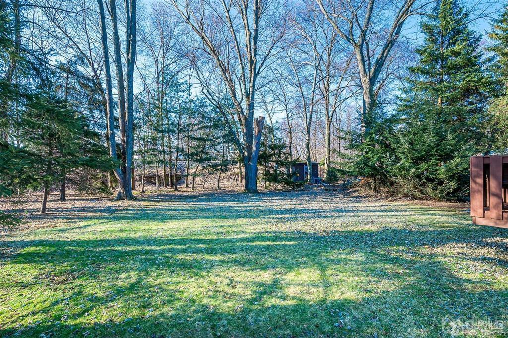 42 Norris Avenue Metuchen, NJ 08840 - Photo 37 of 39 a backyard of a house with lots of green space and fountain