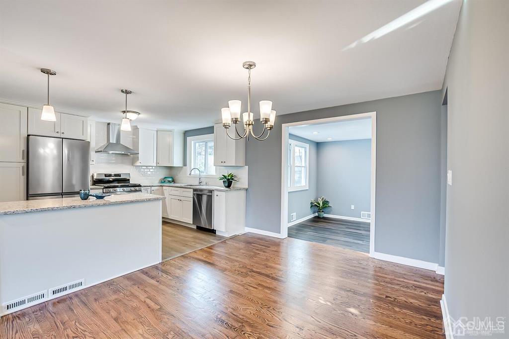 42 Norris Avenue Metuchen, NJ 08840 - Photo 10 of 39 a large kitchen with granite countertop a large counter top and wooden floor