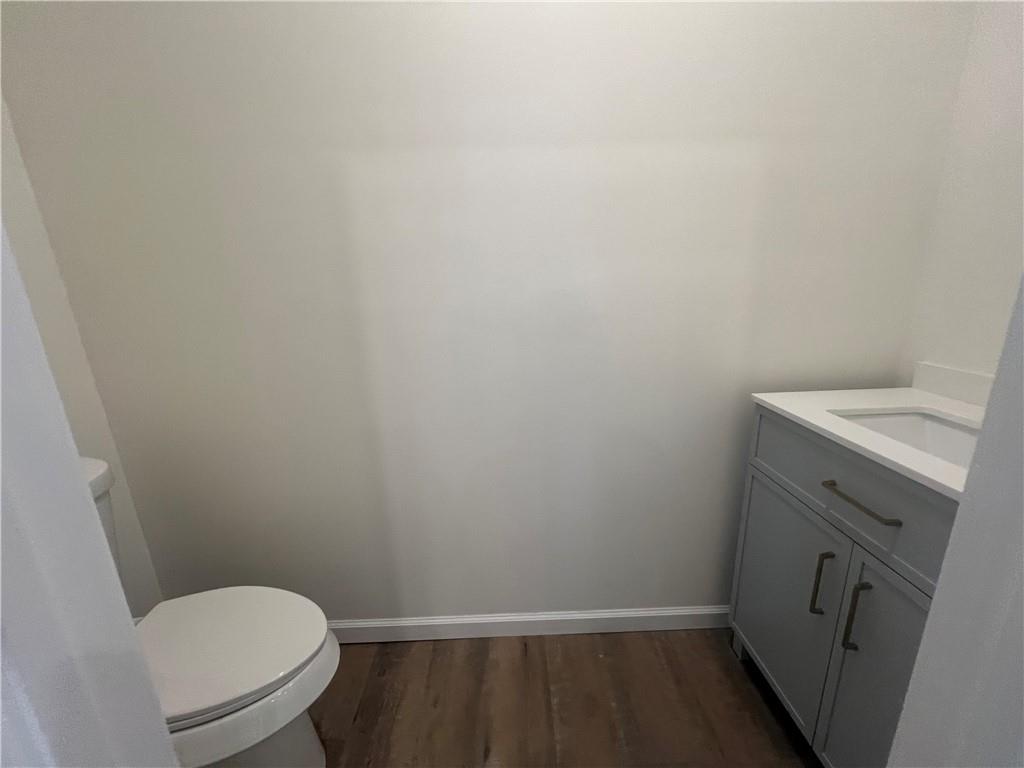 566 Merchant Street, Unit 1 Ambridge, PA 15003 - Photo 6 of 8 a bathroom with a sink toilet and vanity