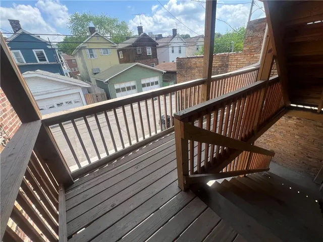 a view of balcony with wooden floor