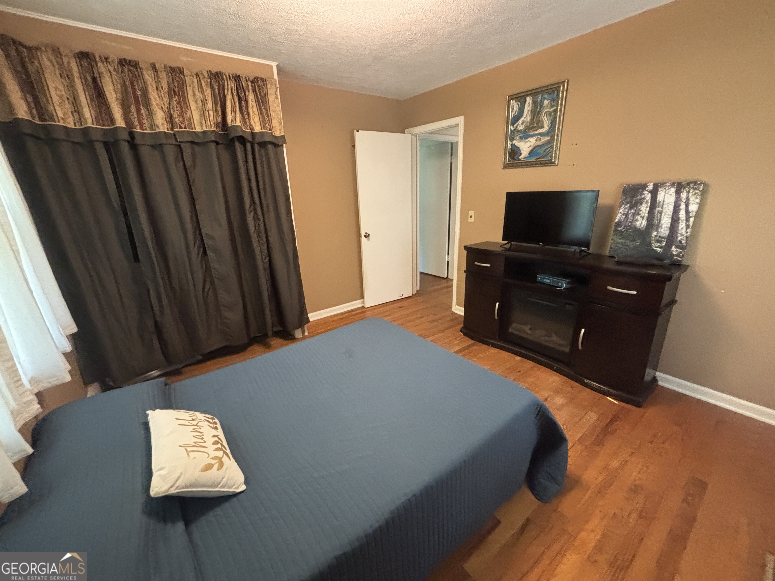 152 Crest Drive Cochran, GA 31014 - Photo 34 of 54 a bedroom with a bed and a television