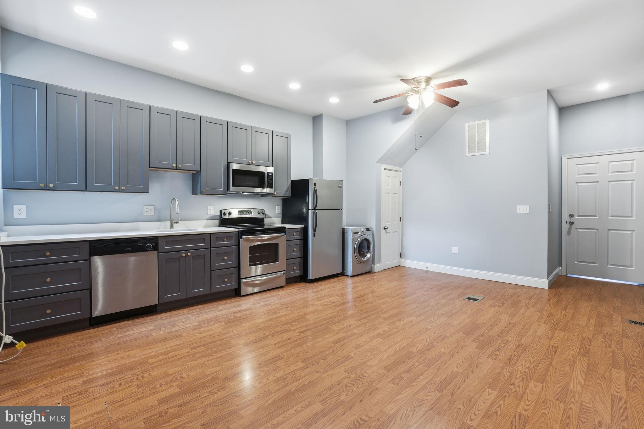 1440 Fairmont Street Northwest, Unit 3 Washington, DC 20009 - Photo 3 of 21 a kitchen with granite countertop a refrigerator and a sink