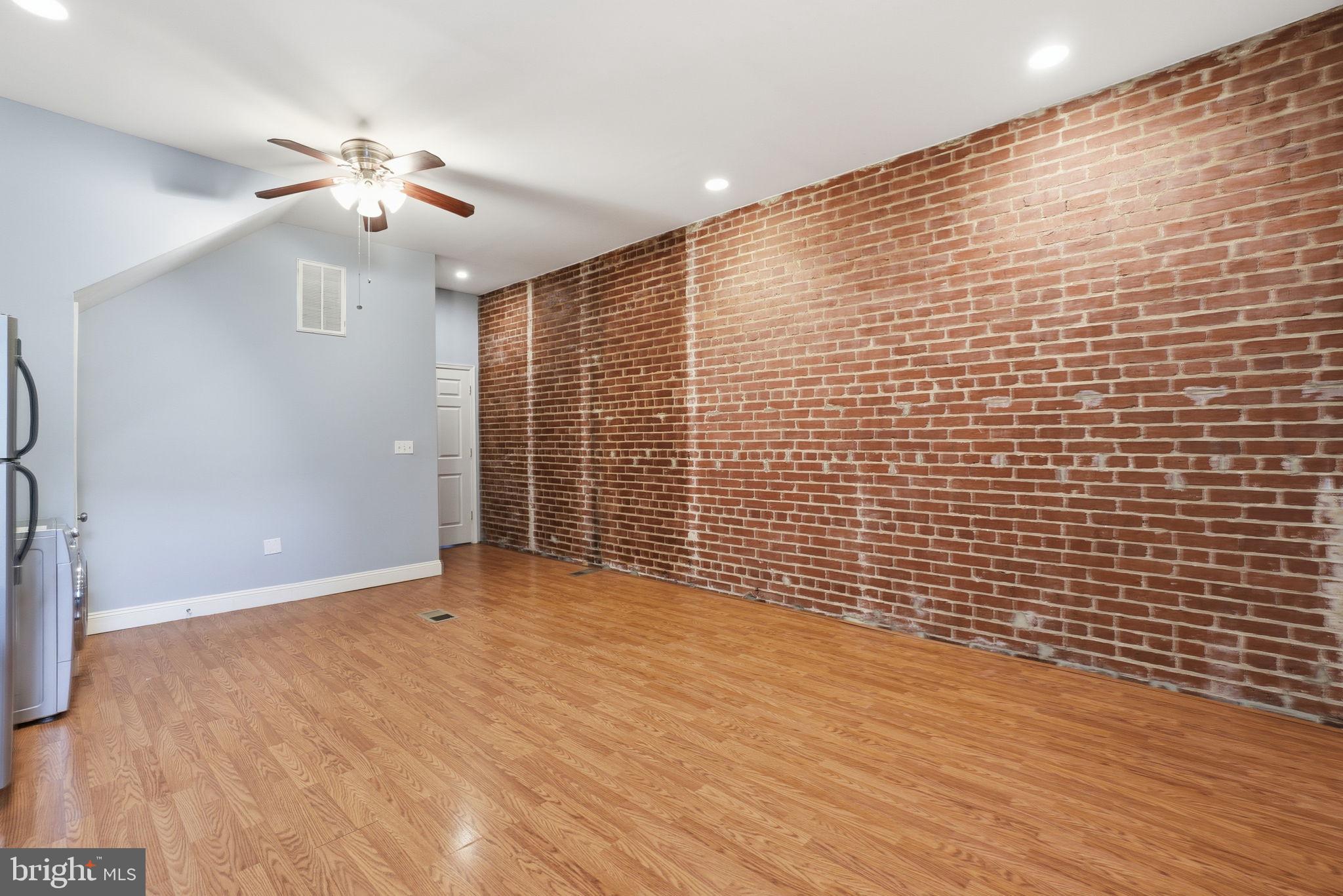1440 Fairmont Street Northwest, Unit 3 Washington, DC 20009 - Photo 7 of 21 a view of an empty room with wooden floor and a ceiling fan