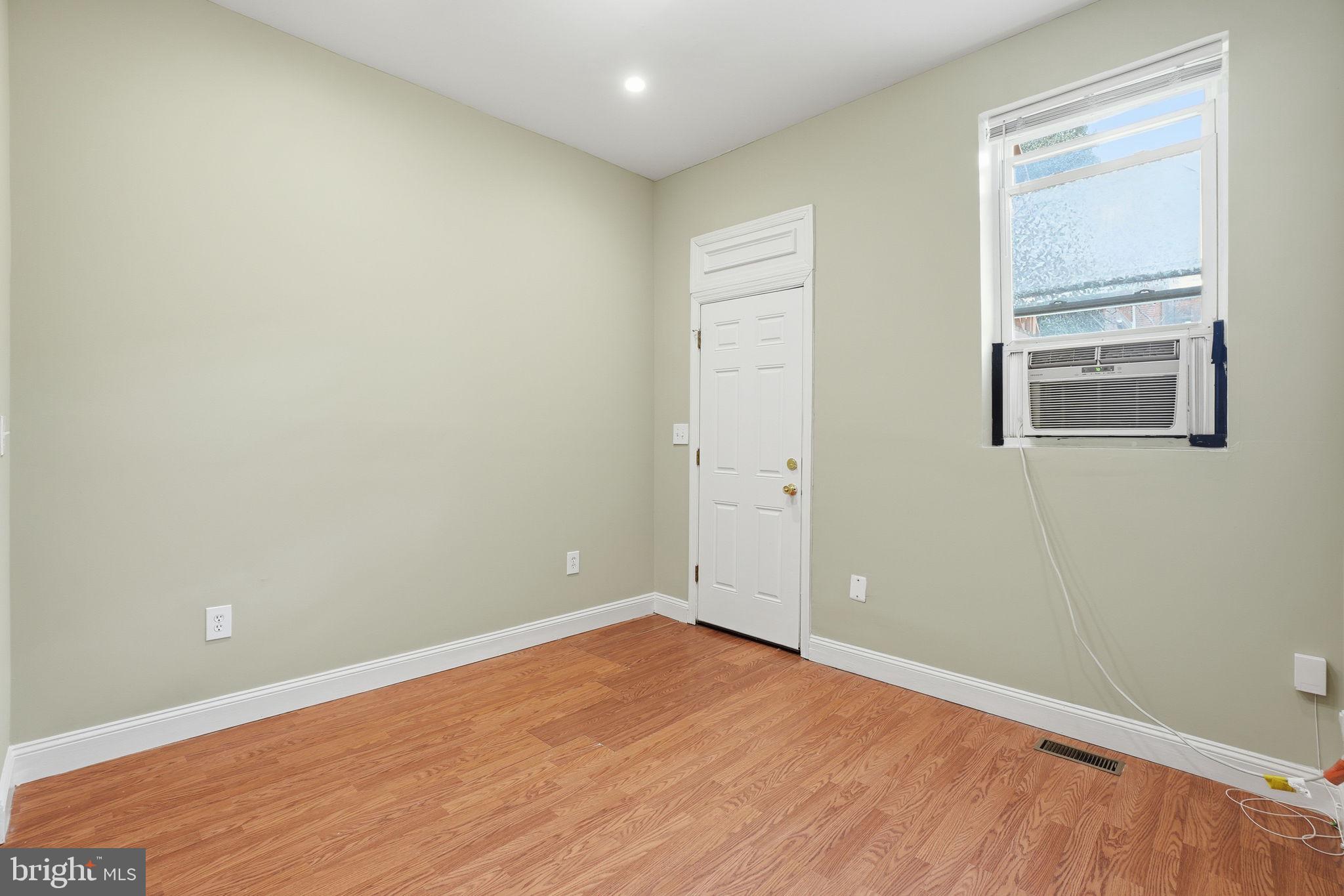 1440 Fairmont Street Northwest, Unit 3 Washington, DC 20009 - Photo 9 of 21 an empty room with wooden floor and windows