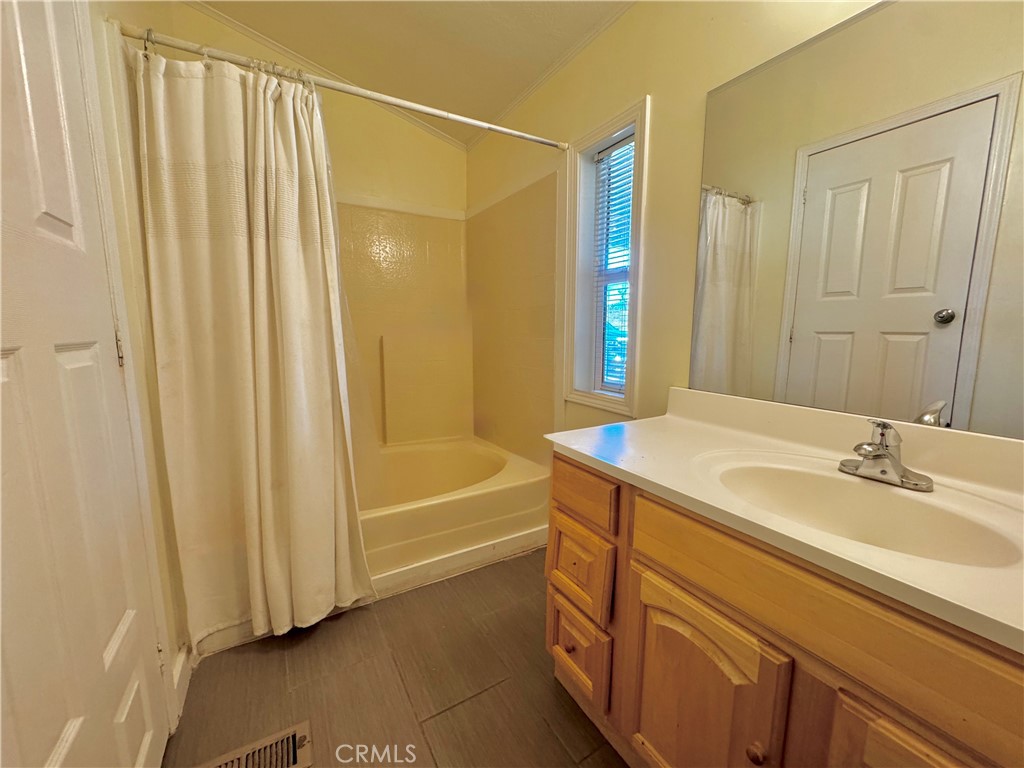 2775 Duncan Road Phelan, CA 92371 - Photo 11 of 29 a bathroom with a granite countertop sink and a mirror