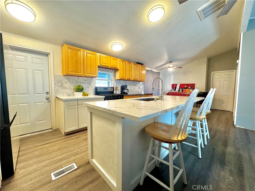 2775 Duncan Road Phelan, CA 92371 - Photo 5 of 29 a kitchen with a sink cabinets and wooden floor
