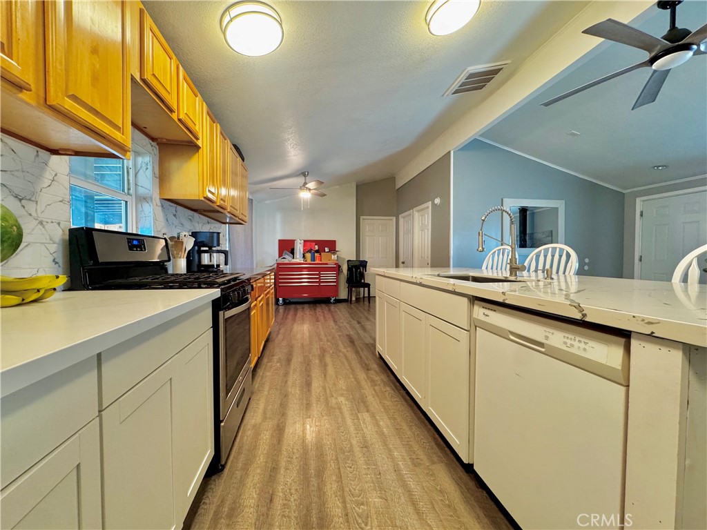 2775 Duncan Road Phelan, CA 92371 - Photo 6 of 29 a kitchen with stainless steel appliances granite countertop sink stove top oven and cabinets