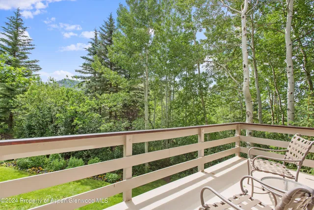 a view of balcony with wooden floor and fence