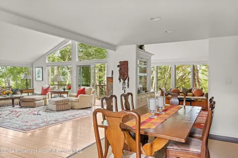 a living room with furniture and large windows