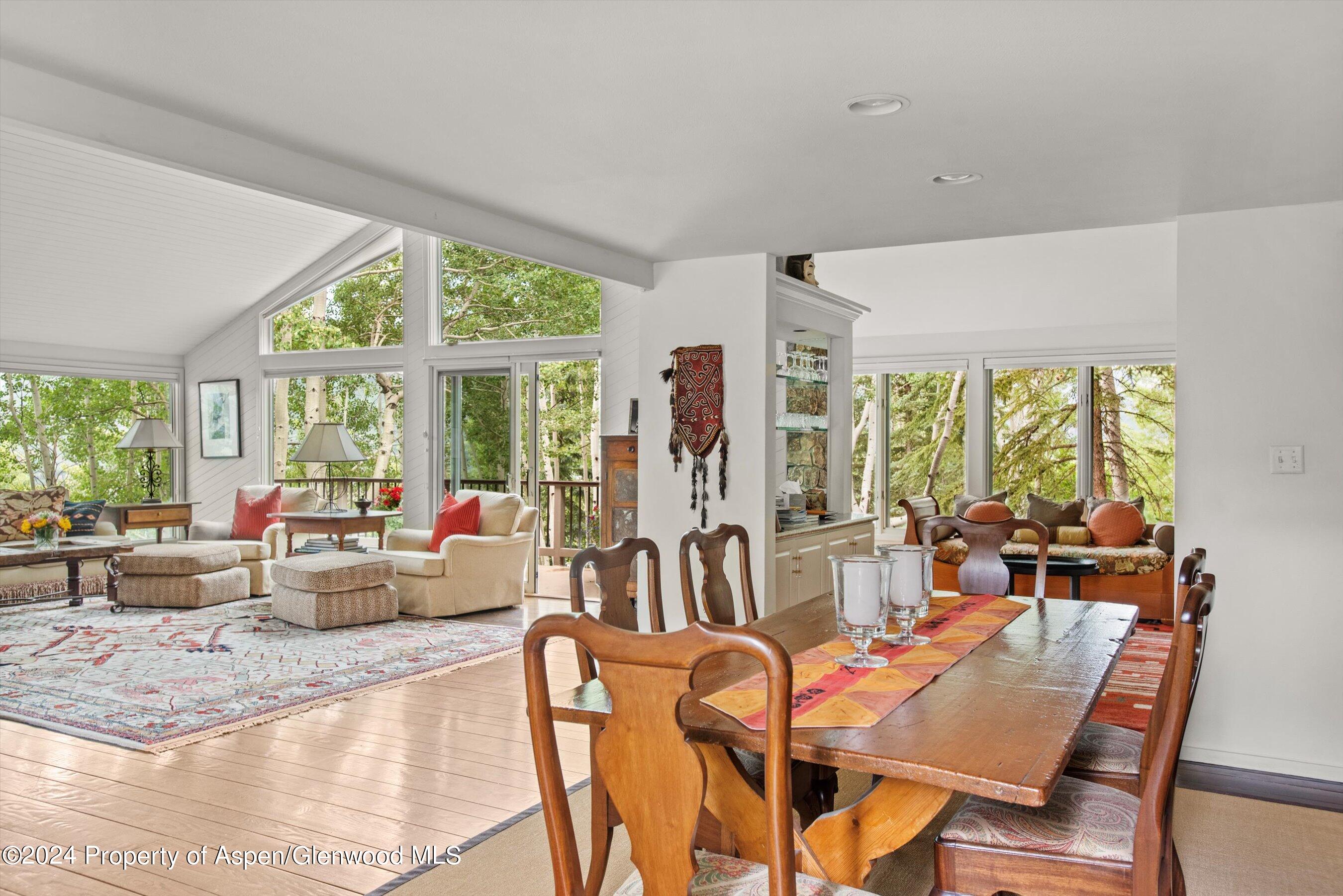 209 Larkspur Lane Aspen, CO 81611 - Photo 15 of 45 a living room with furniture and large windows