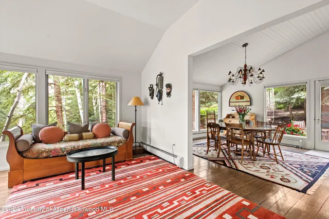 a living room with furniture a rug and a chandelier