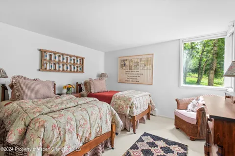 a bedroom with two beds and a window