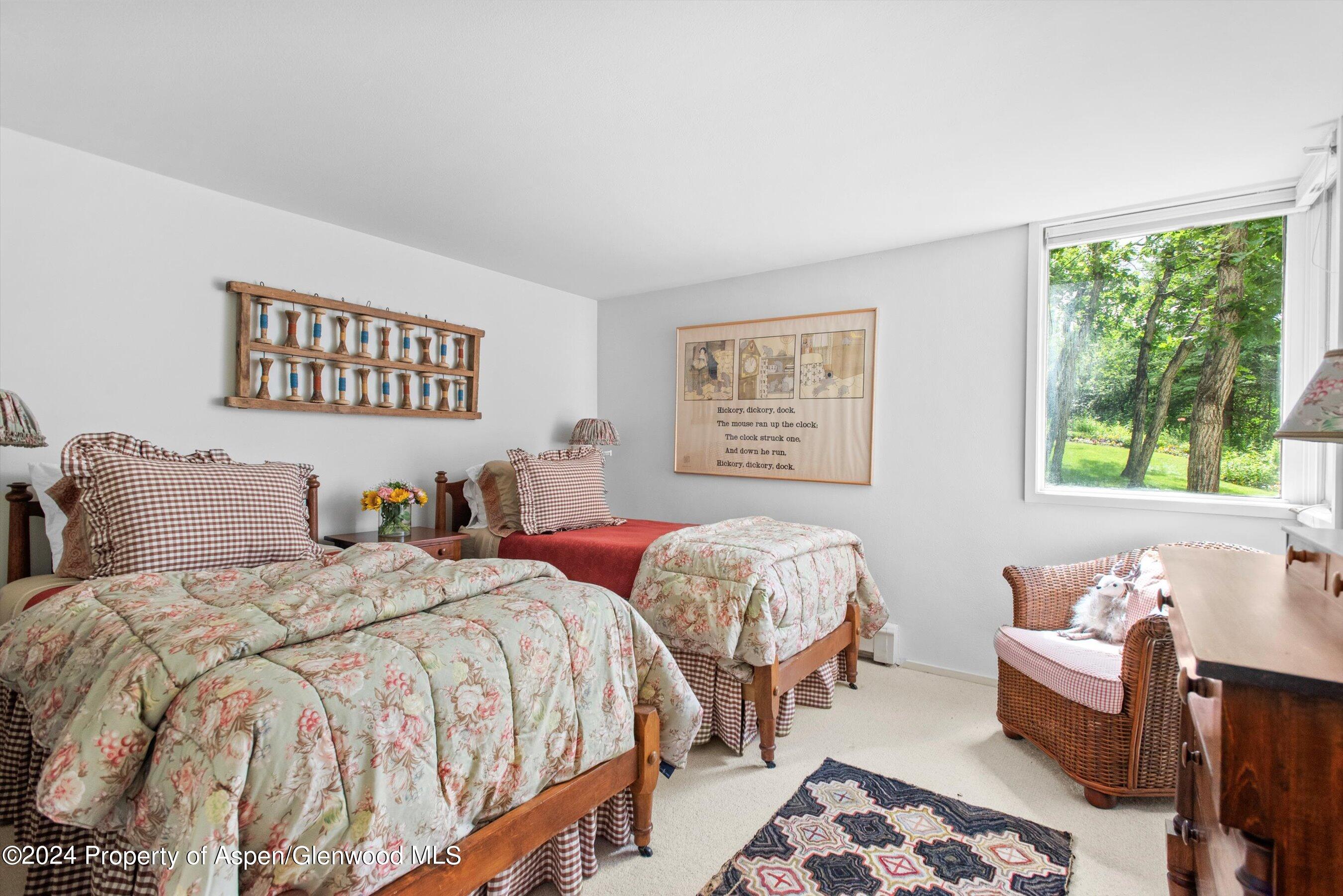 209 Larkspur Lane Aspen, CO 81611 - Photo 28 of 45 a bedroom with two beds and a window