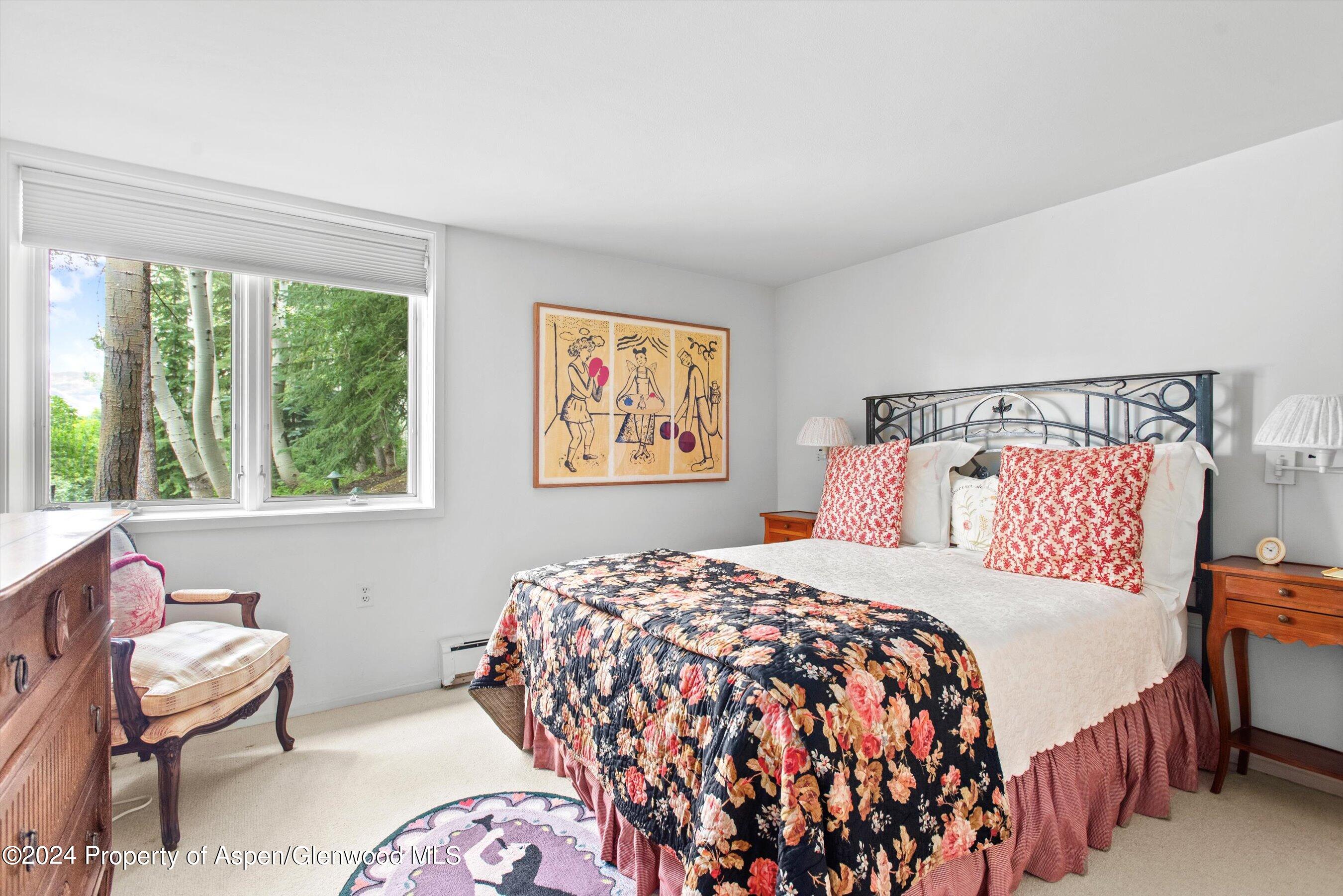 209 Larkspur Lane Aspen, CO 81611 - Photo 30 of 45 a bedroom with a bed and a painting on the wall