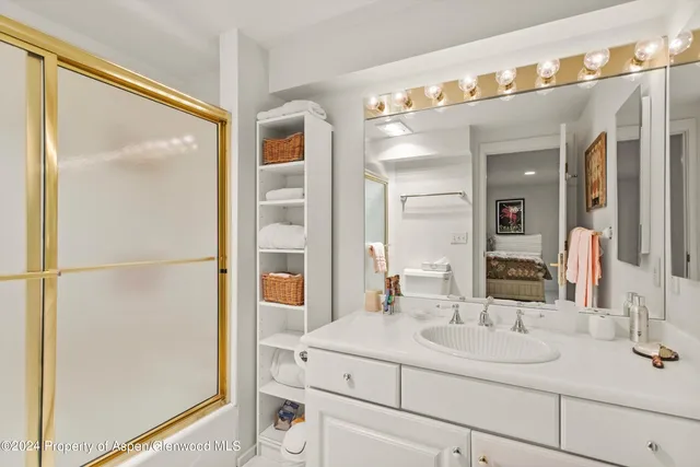 a bathroom with a sink and mirror