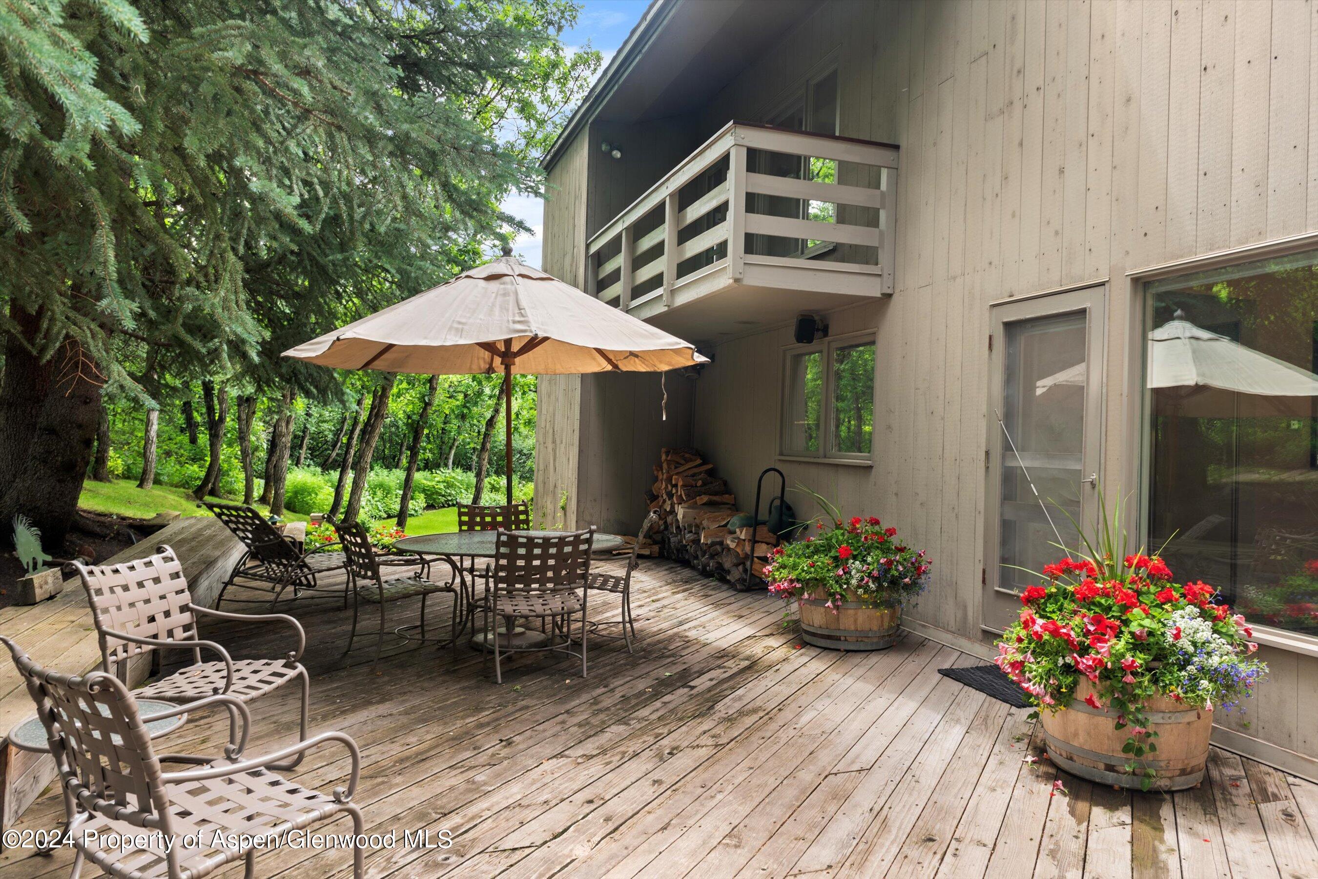209 Larkspur Lane Aspen, CO 81611 - Photo 37 of 45 a view of a chairs and table in the patio with a fire pit