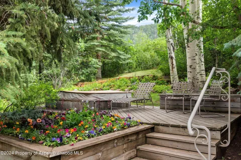 a view of a wooden bench with potted plants