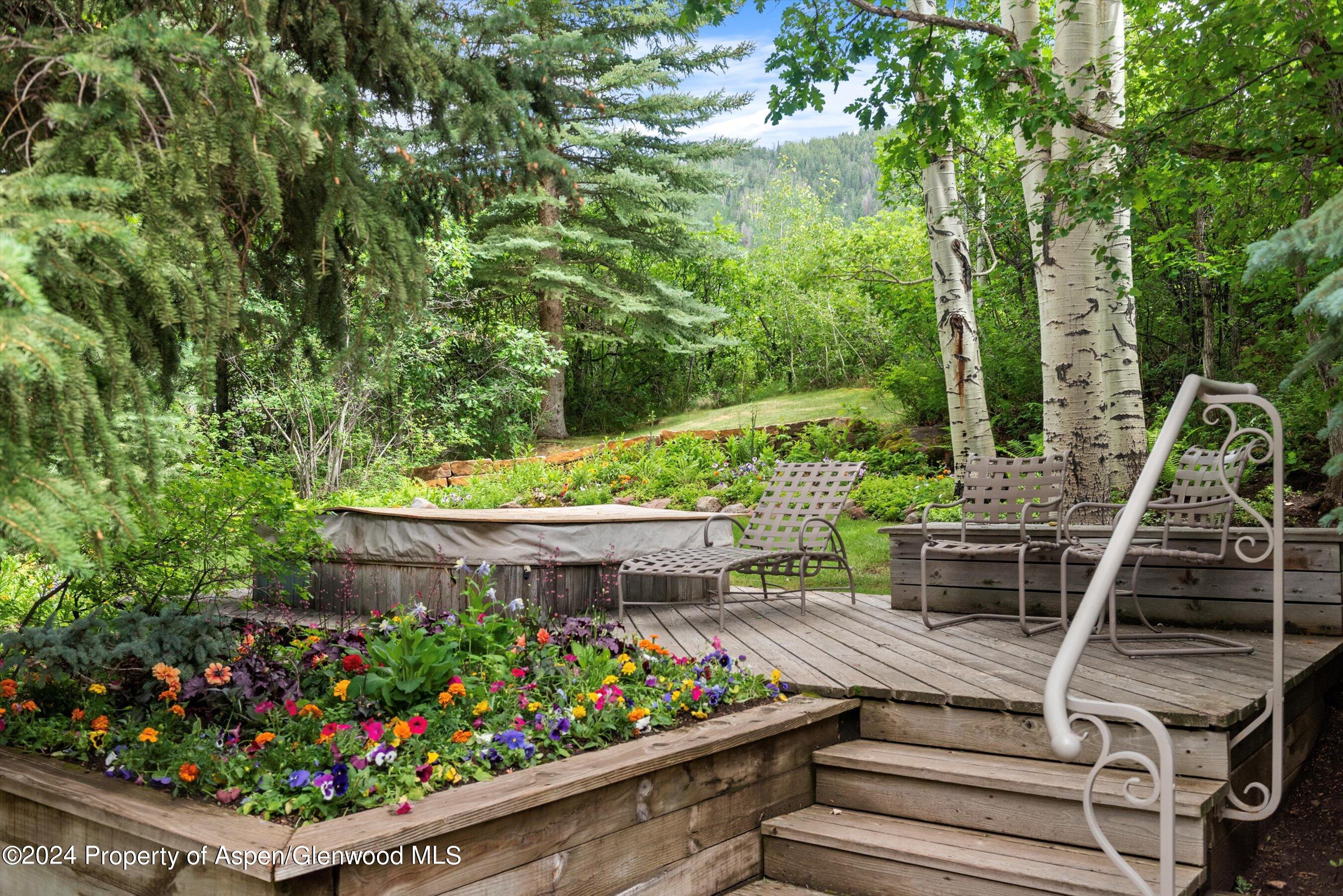 209 Larkspur Lane Aspen, CO 81611 - Photo 38 of 45 a view of a wooden bench with potted plants