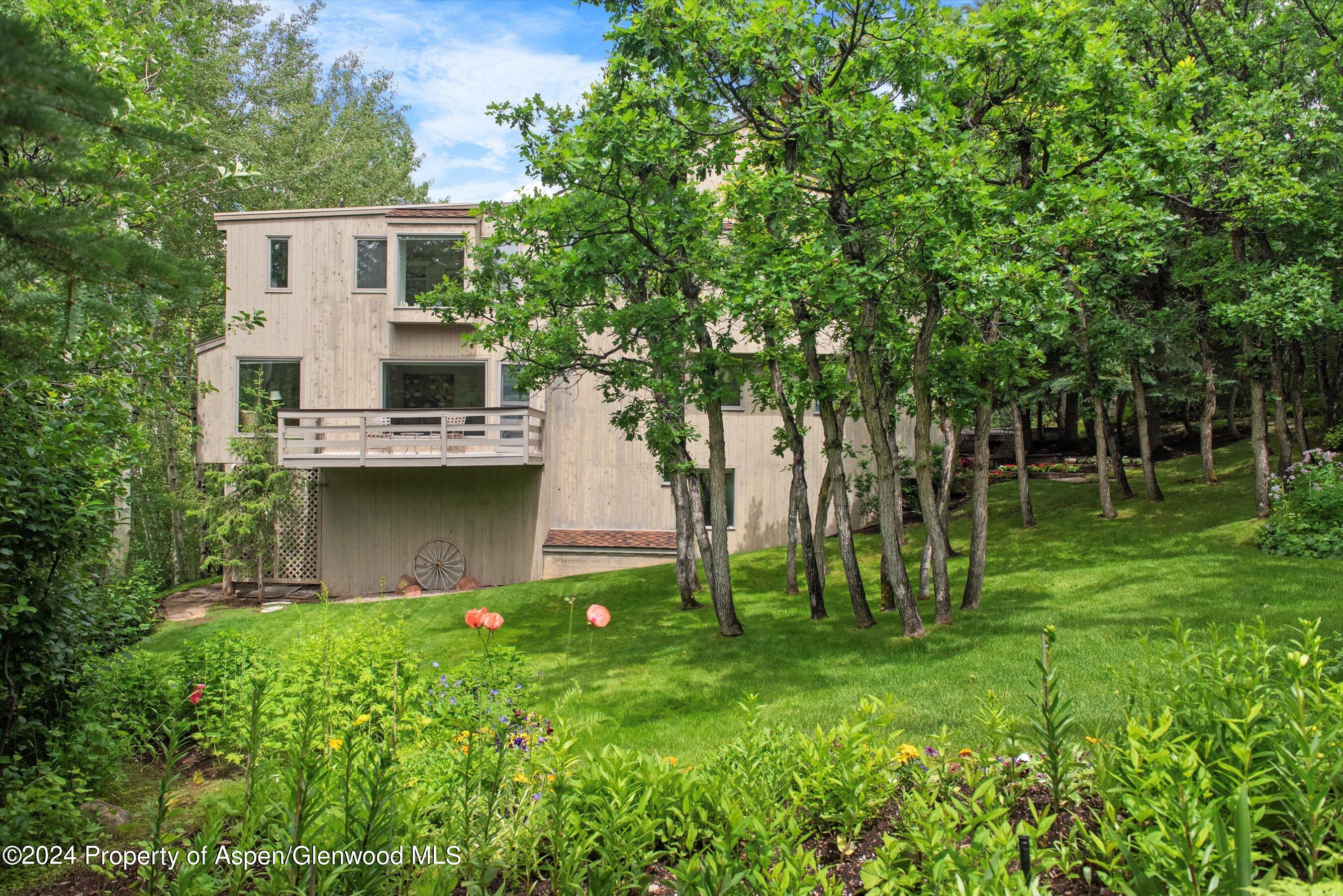 209 Larkspur Lane Aspen, CO 81611 - Photo 40 of 45 a front view of a house with garden