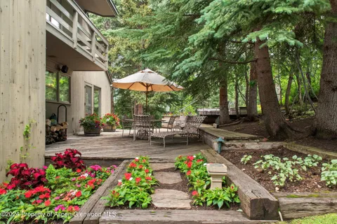 a view of a house with a yard and sitting area