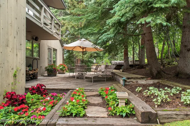a view of a house with a yard and sitting area
