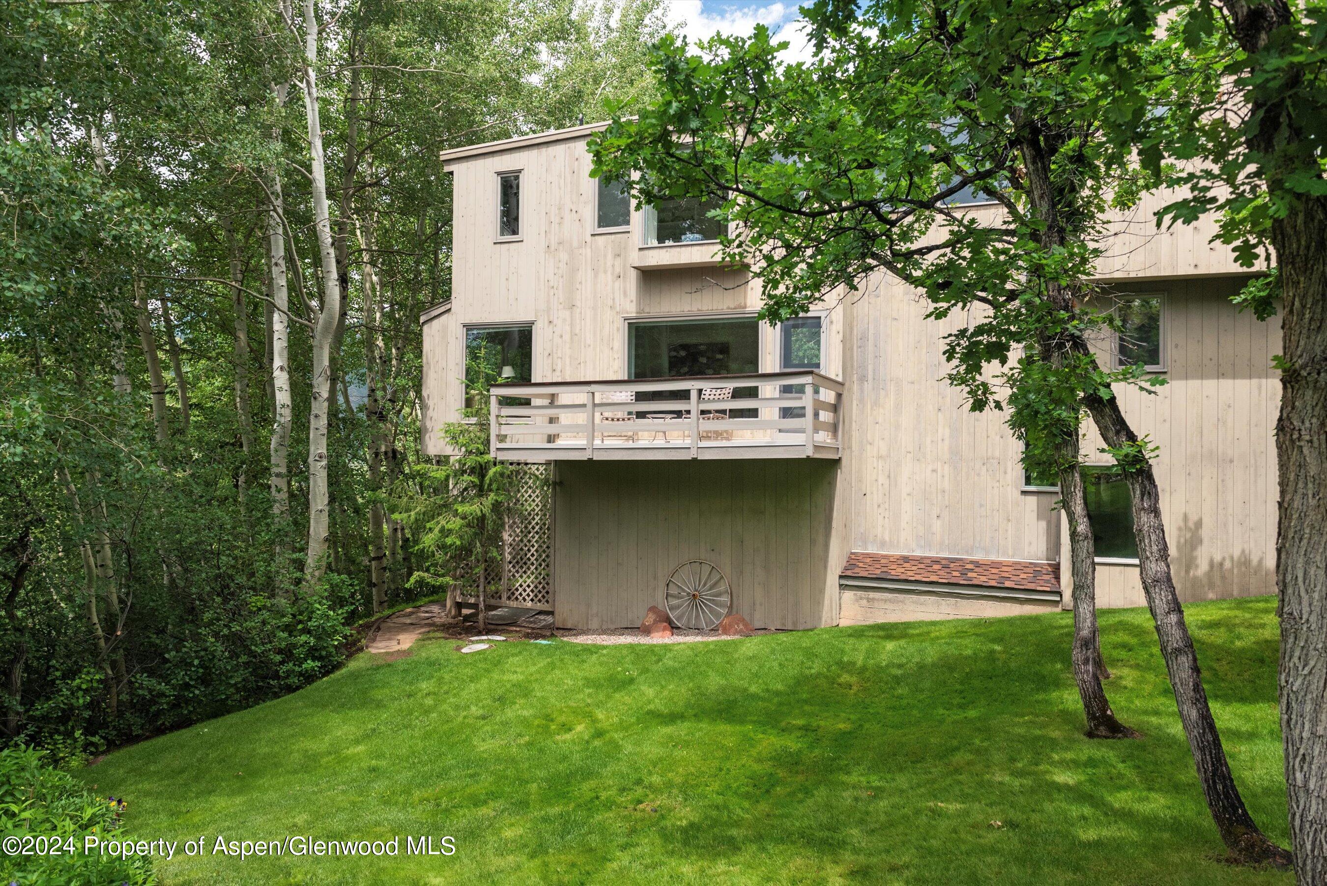209 Larkspur Lane Aspen, CO 81611 - Photo 41 of 45 a view of a house with backyard and a garden