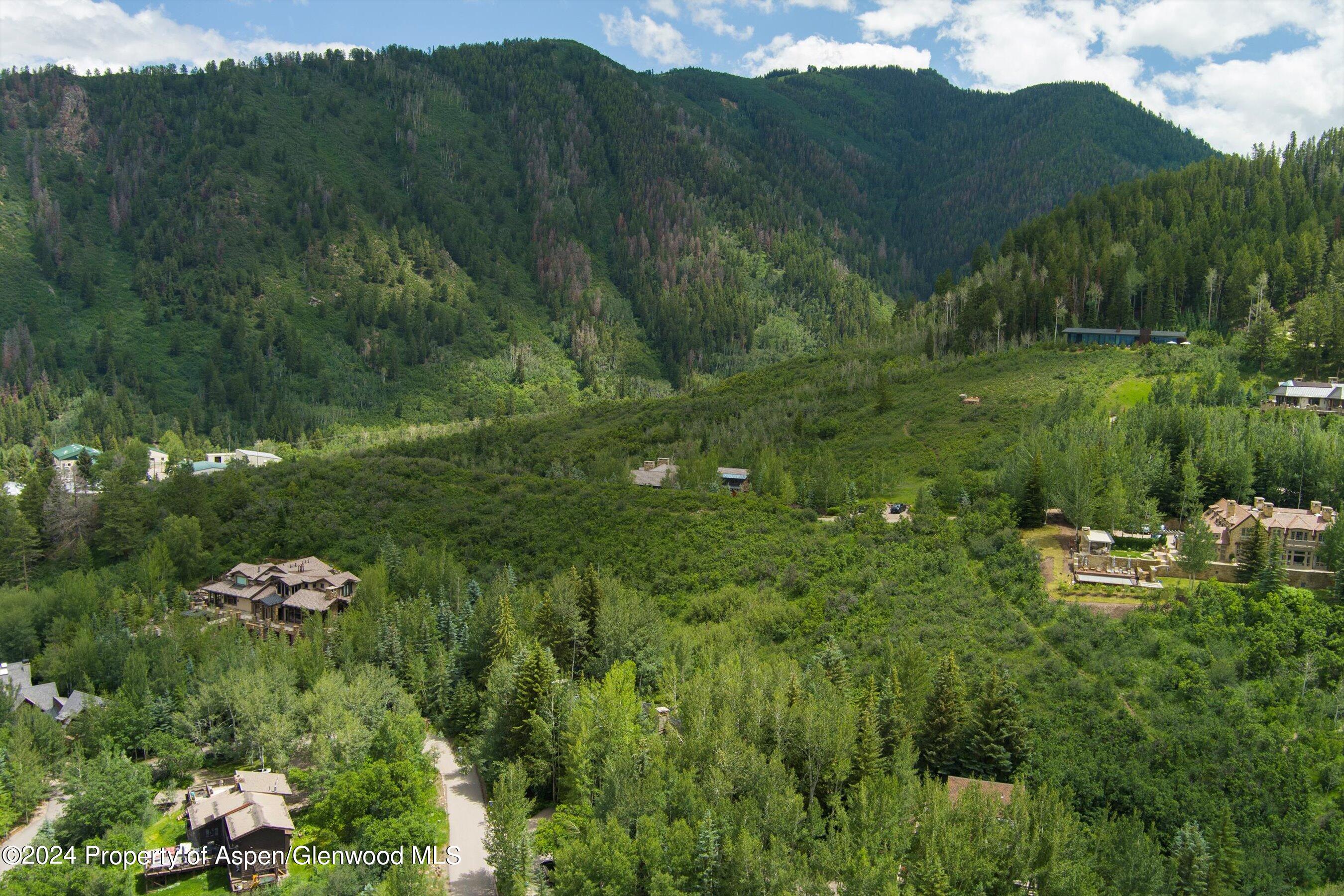 209 Larkspur Lane Aspen, CO 81611 - Photo 44 of 45 a view of a lake with a house in the background