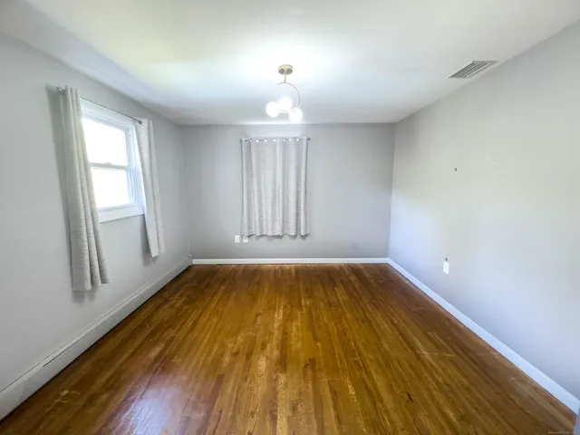 a bed room with furniture and wooden floor