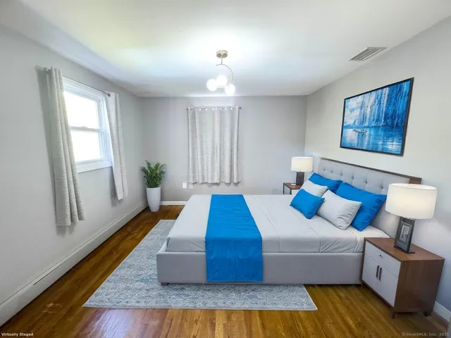 a bedroom with a bed and window