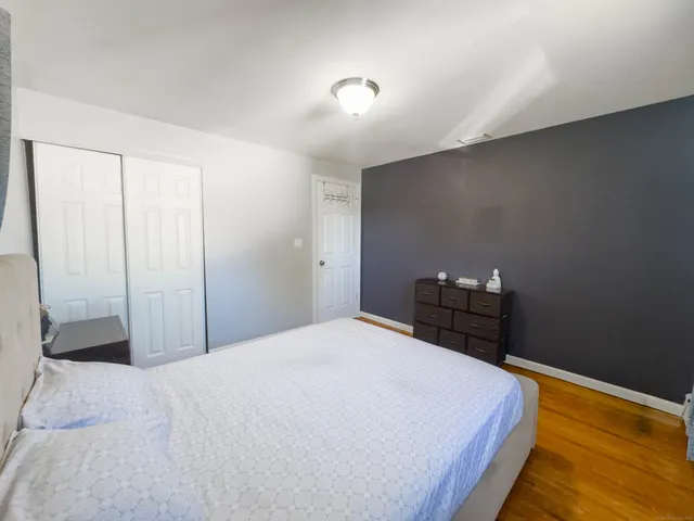 a bed sitting in a bedroom next to a window