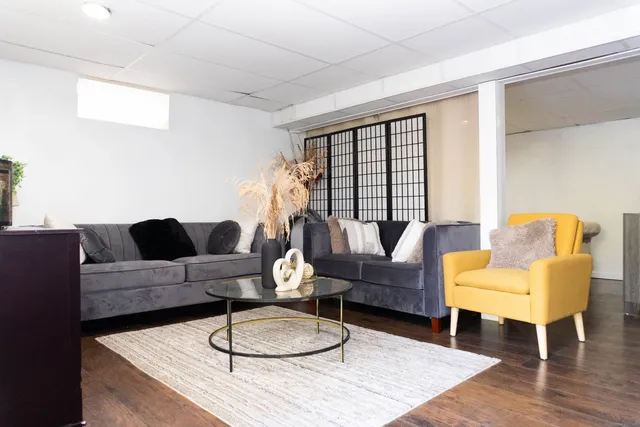 a living room with furniture and wooden floor