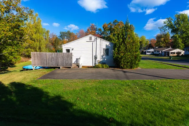 a front view of a house with a garden and yard