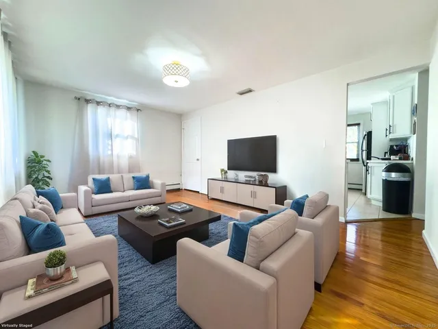 a view of a room with wooden floor and bathroom