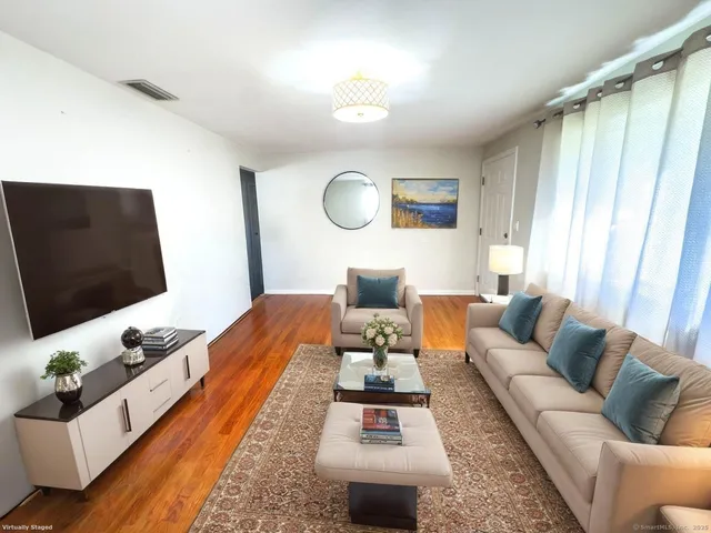 a kitchen with cabinets stainless steel appliances and wooden floor