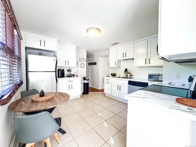 a kitchen with cabinets stainless steel appliances and sink