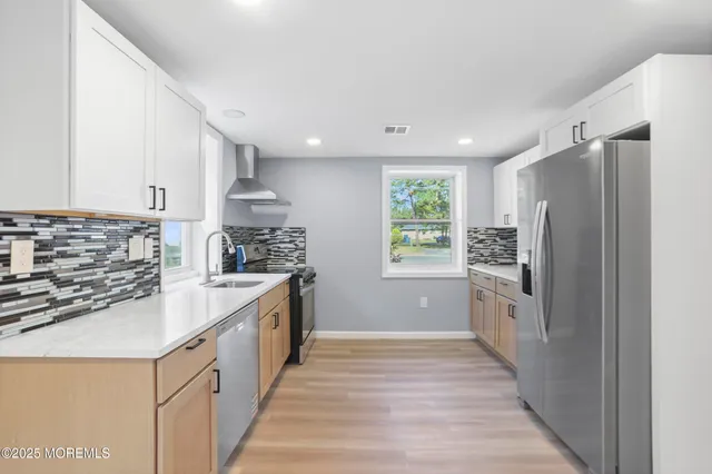 a kitchen with granite countertop a refrigerator and a sink