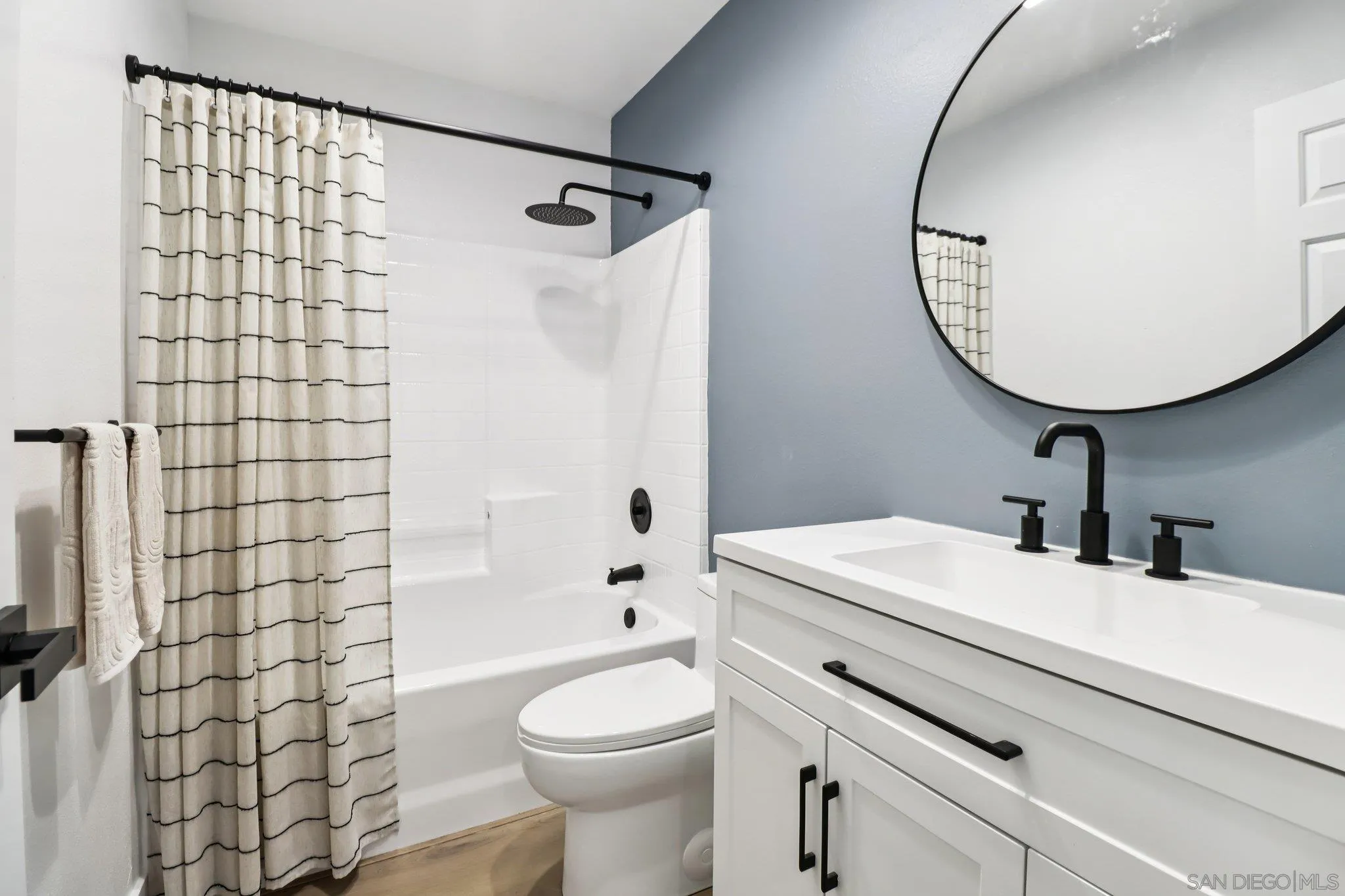 2082 Fairhope Loop Vista, CA 92081 - Photo 16 of 27 a bathroom with a sink a toilet and shower