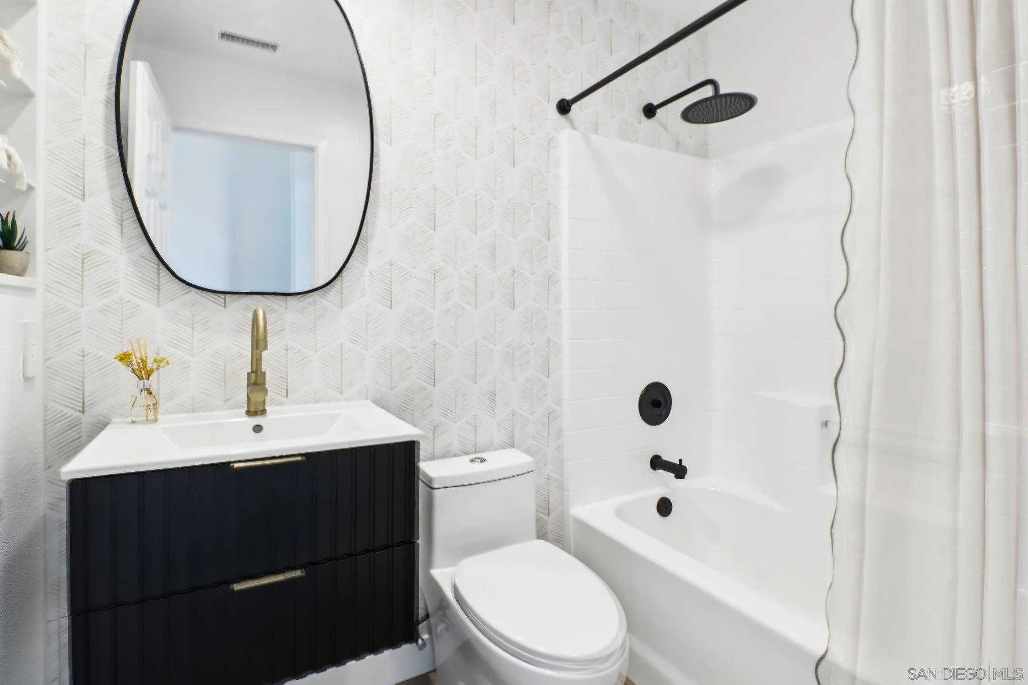 2082 Fairhope Loop Vista, CA 92081 - Photo 18 of 27 a bathroom with a sink a toilet and shower
