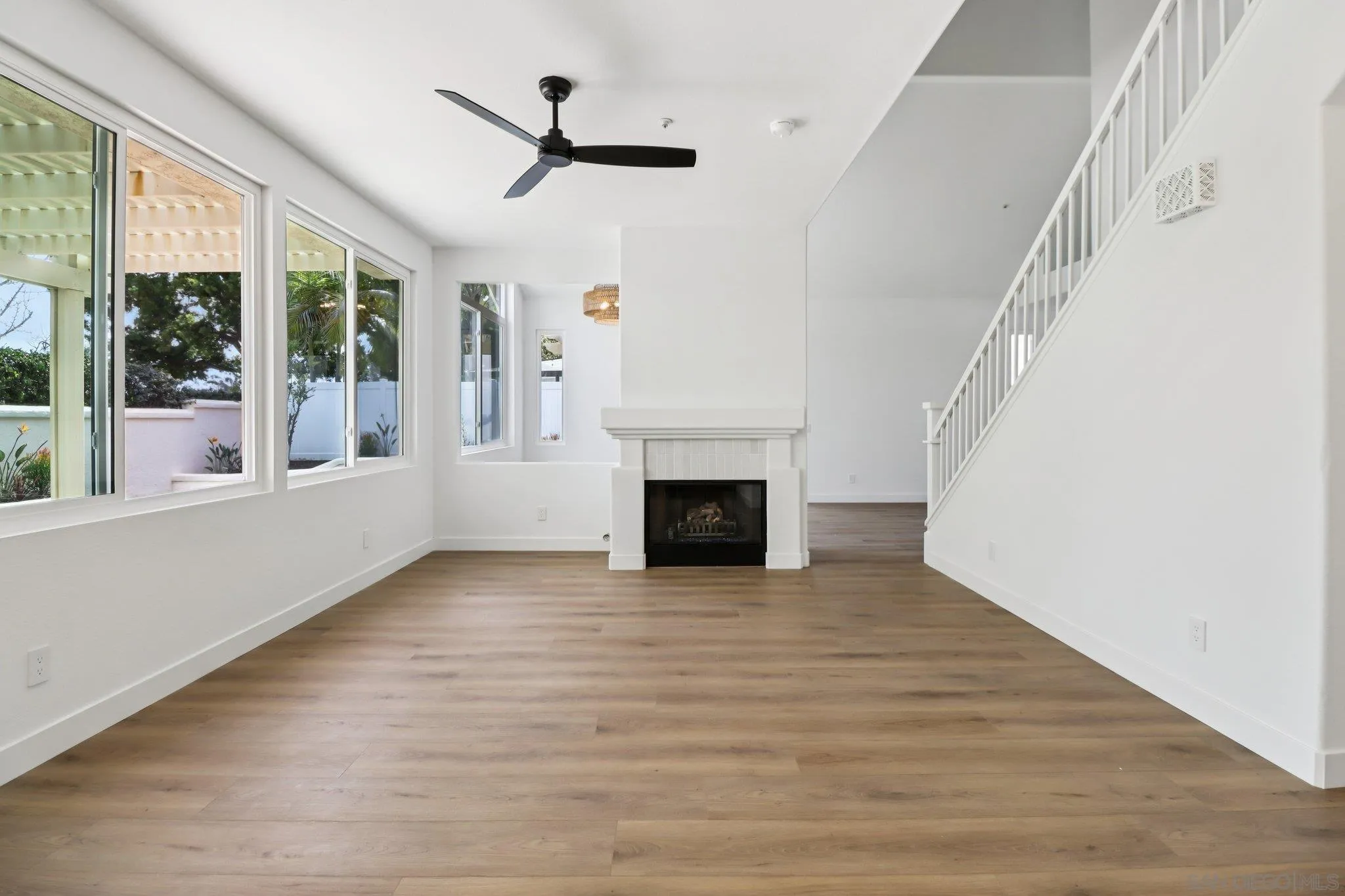 2082 Fairhope Loop Vista, CA 92081 - Photo 2 of 27 a view of a livingroom with wooden floor a fireplace and window