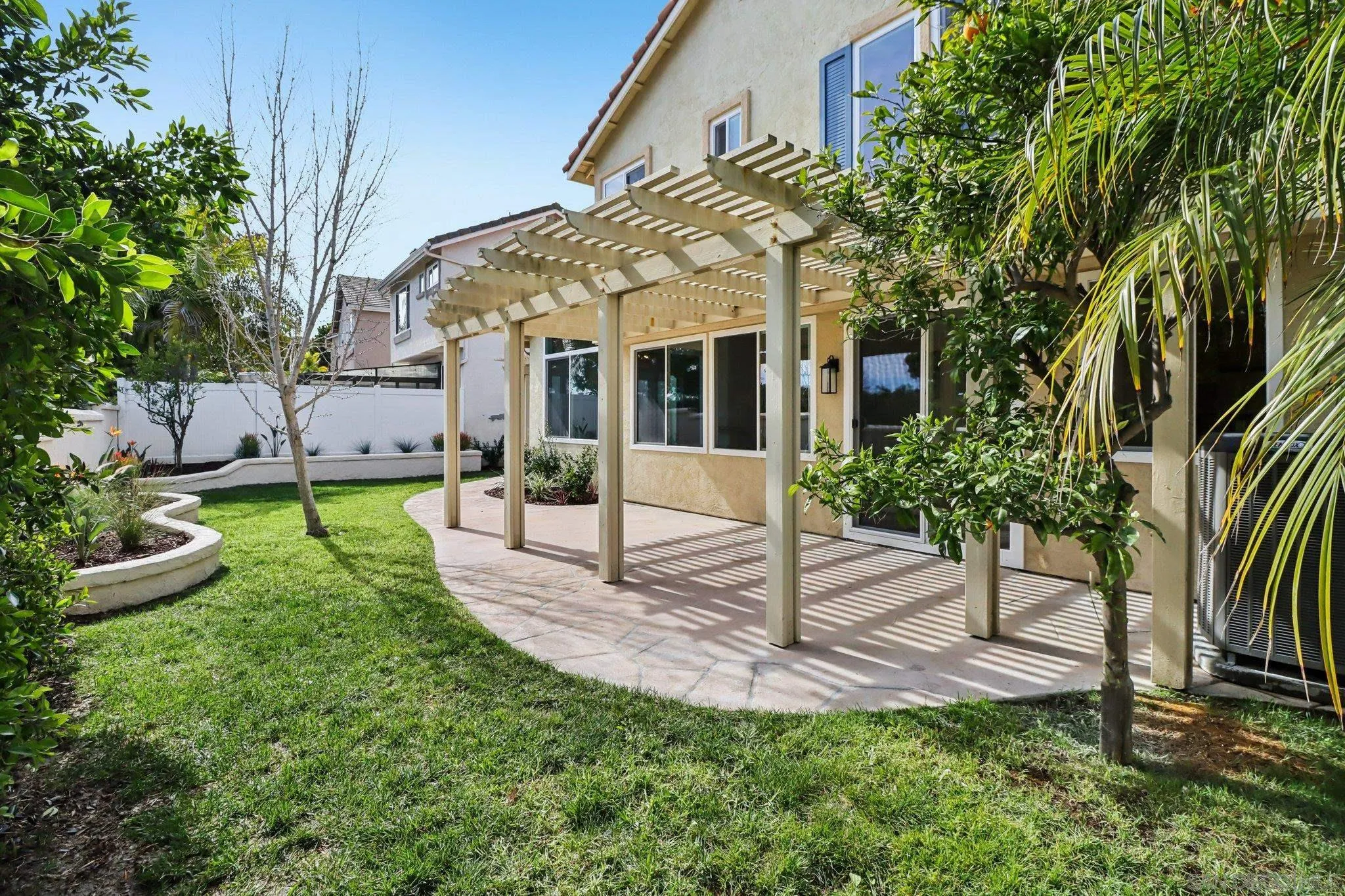 2082 Fairhope Loop Vista, CA 92081 - Photo 22 of 27 a view of a house with a yard and potted plants