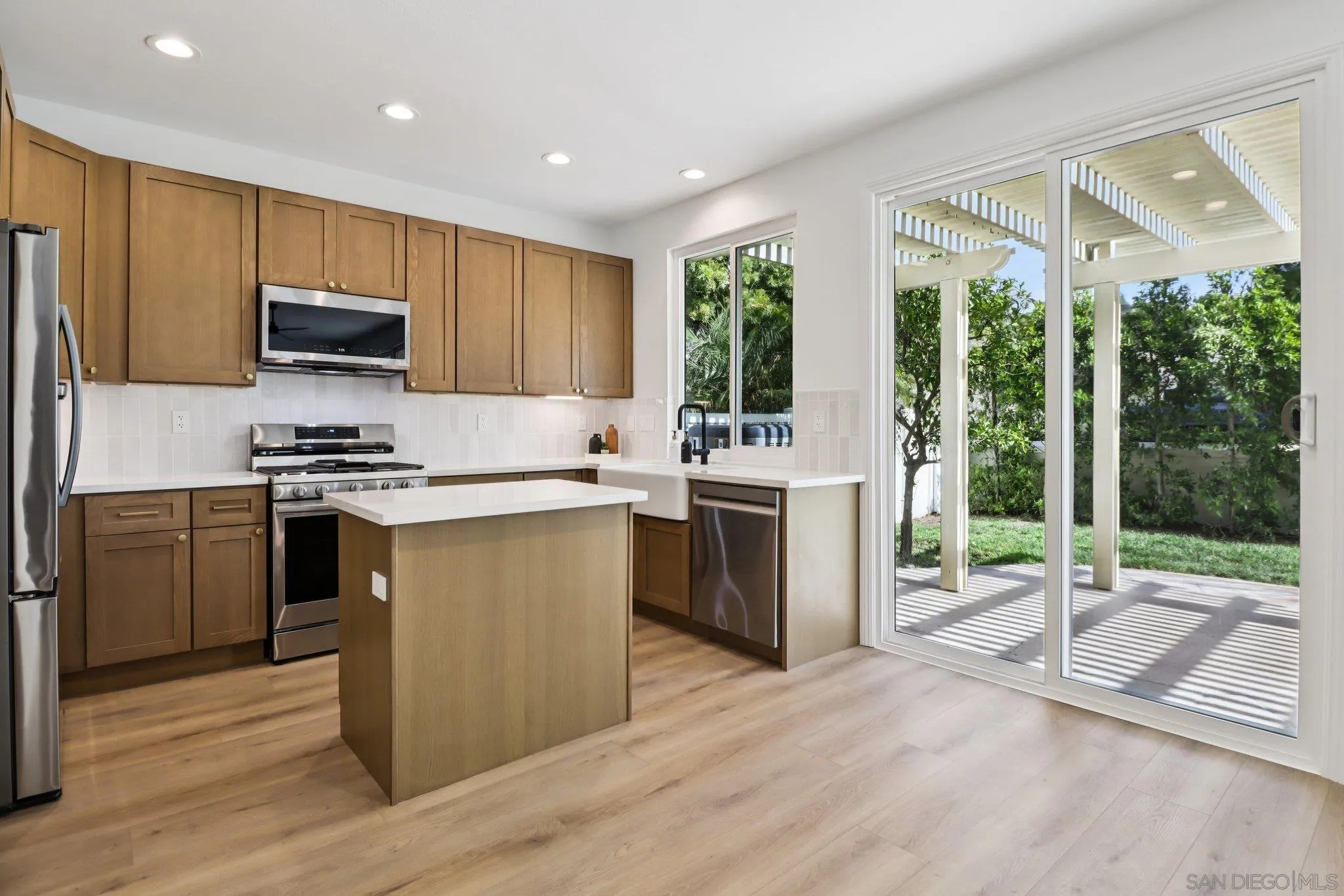 2082 Fairhope Loop Vista, CA 92081 - Photo 5 of 27 a kitchen with a stove a sink and a microwave