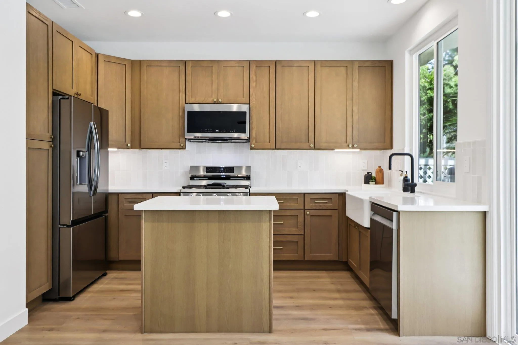 2082 Fairhope Loop Vista, CA 92081 - Photo 6 of 27 a kitchen with a refrigerator sink and microwave
