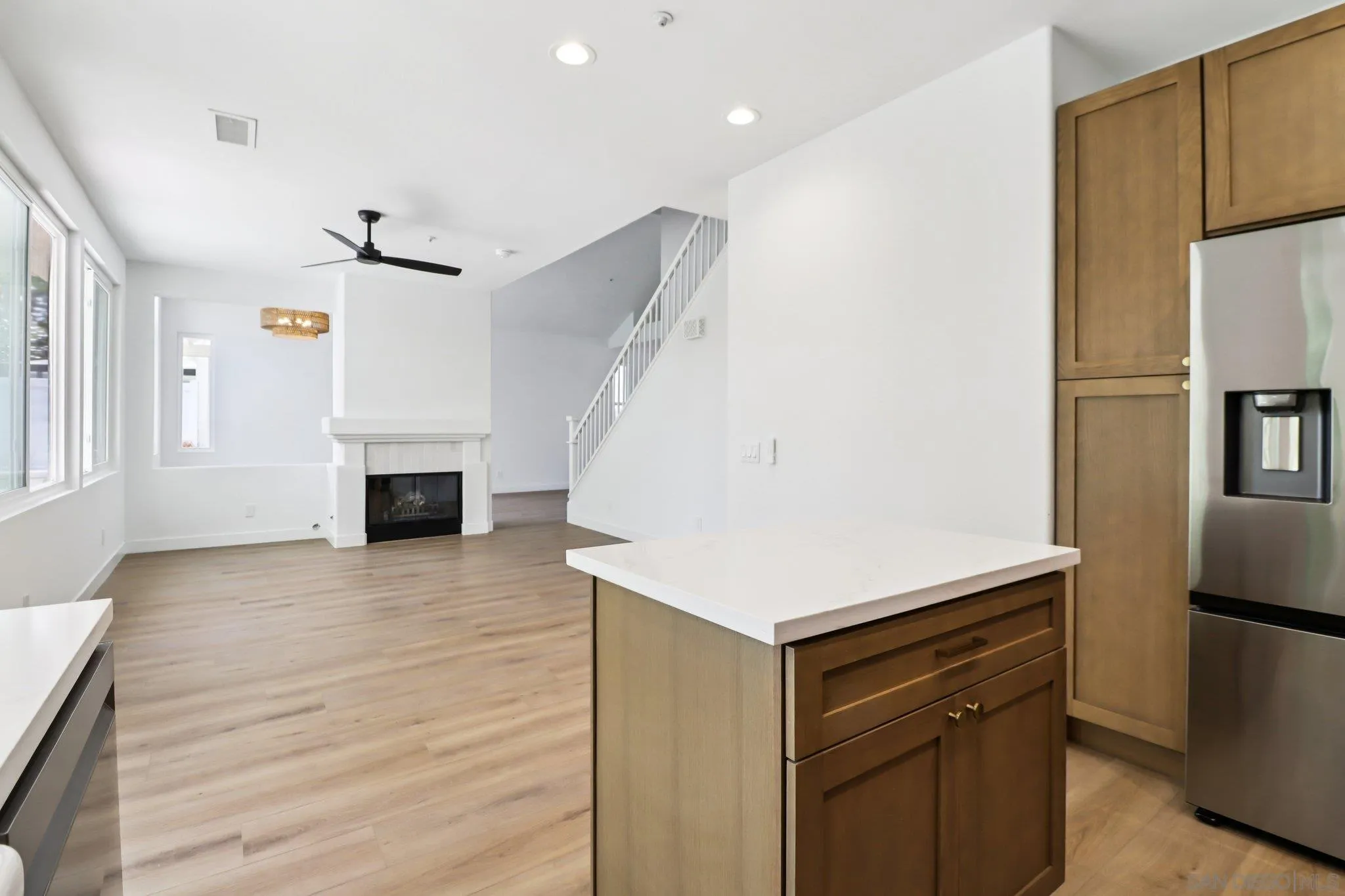 2082 Fairhope Loop Vista, CA 92081 - Photo 7 of 27 a view of kitchen and hallway with wooden floor