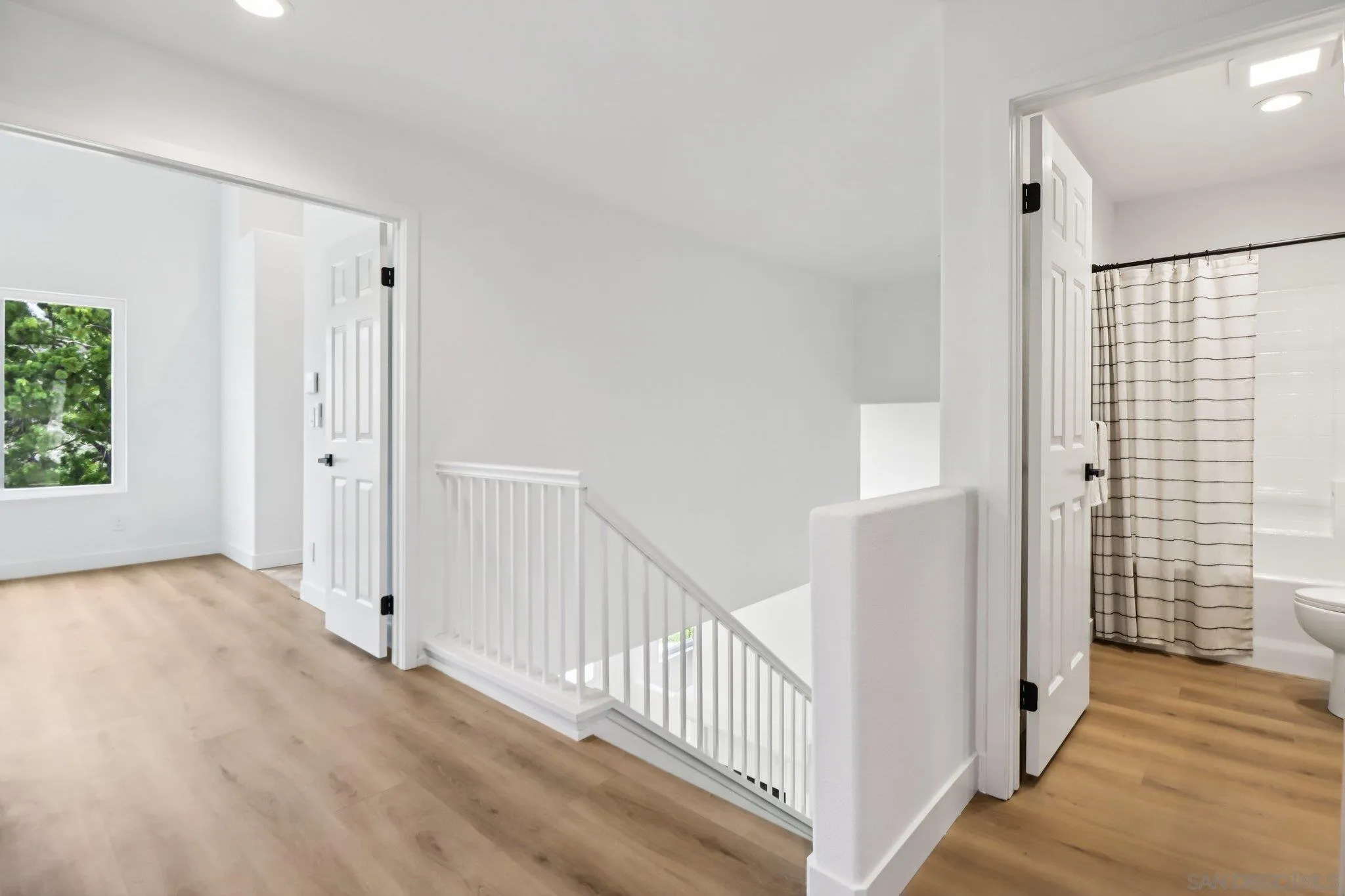 2082 Fairhope Loop Vista, CA 92081 - Photo 9 of 27 a view of a hallway with wooden floor and windows