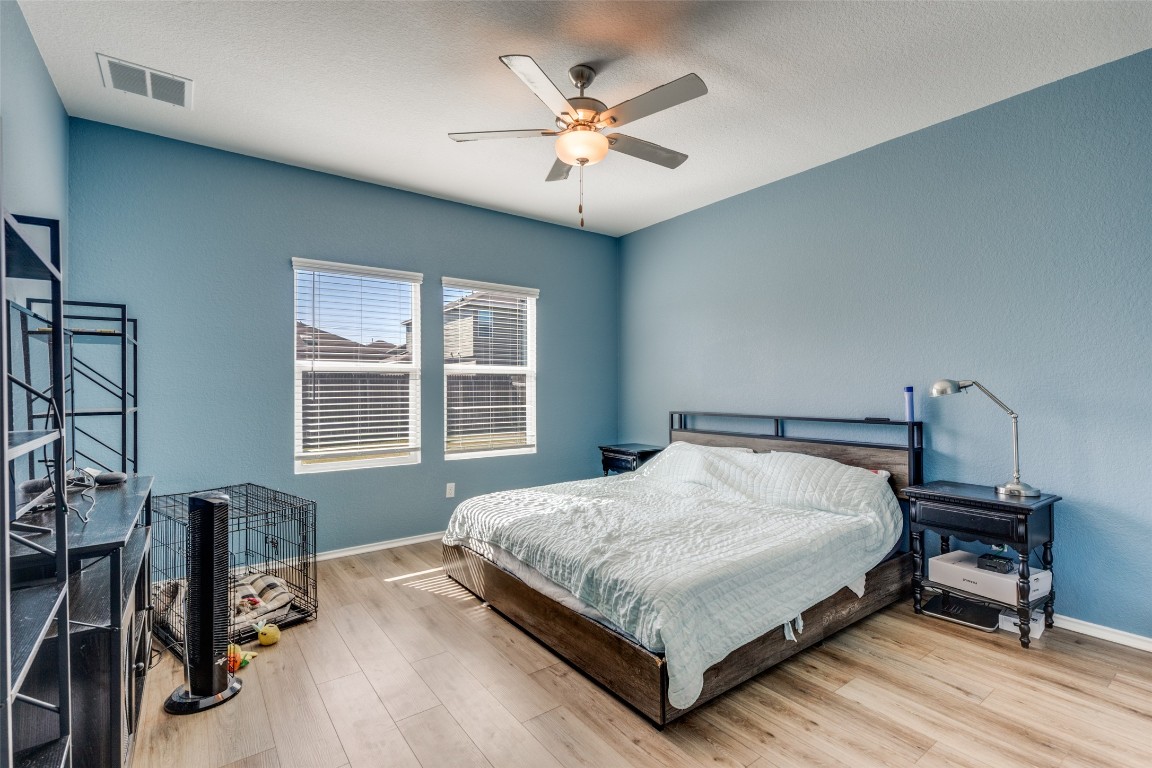 207 Otter Road Kyle, TX 78640 - Photo 13 of 26 a bedroom with a bed table and a window